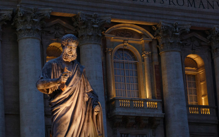 The balcony where the new pope will be introduced to the world is seen at the Vatican behind the statue of St. Peter Feb. 26. (CNS/Paul Haring)