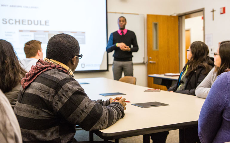 Derek Brinkley, admission representative for Arrupe College, speaks to prospective Arrupe students and their parents during a tour of the campus Feb. 16 in Chicago. (Loyola University Chicago/Heather Edison)