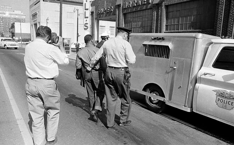 A police officer leads the Rev. Martin Luther King Jr. away after his arrest in Birmingham, Ala., on April 13, 1963. (AP)