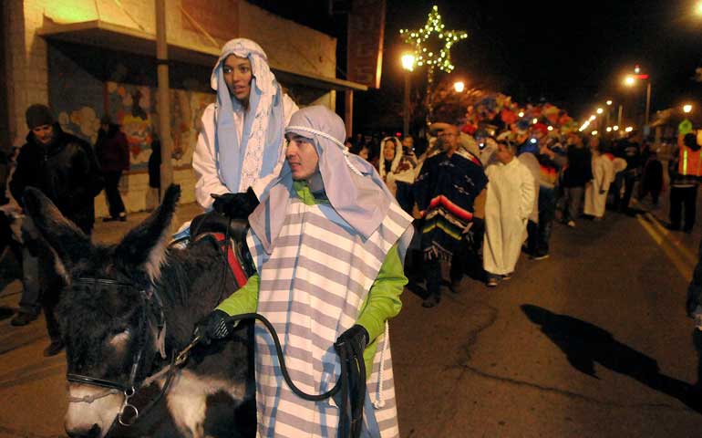 Raylynn Maestas as Mary and Joseph Clark as Joseph lead Las Posadas in Albuquerque, N.M., Dec. 21, 2013. (Newscom/ZUMA Press/Greg Sorber)