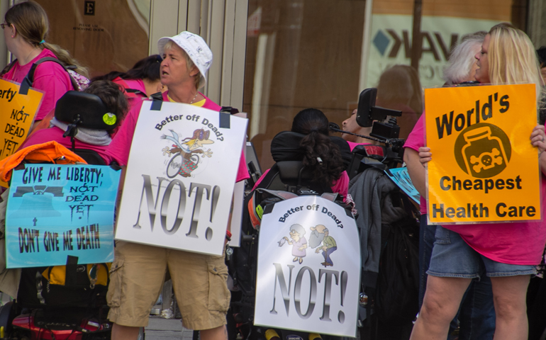 Members of Not Dead Yet and other disability rights activists hold a vigil Sept. 19, 2014, in Chicago, outside a conference held by the World Federation of Right to Die Societies. (Carrie Ann Lucas)