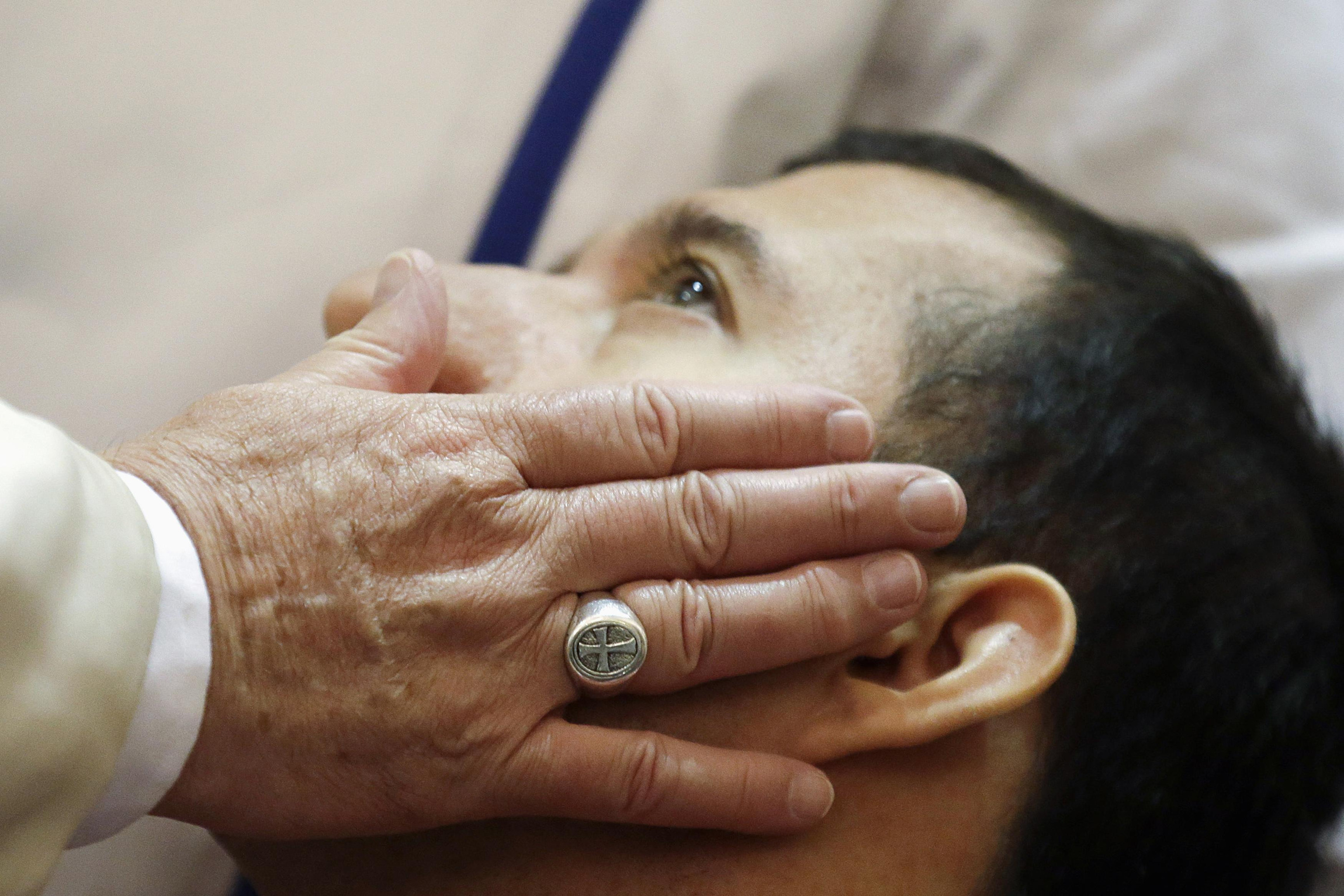 Francis blesses disabled man n Assisi (CNS photo)