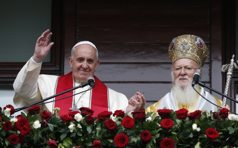 Pope Francis and Ecumenical Patriarch Bartholomew of Constantinople greet a small crowd after delivering a blessing in Istanbul Nov. 30. (CNS photo/Paul Haring)