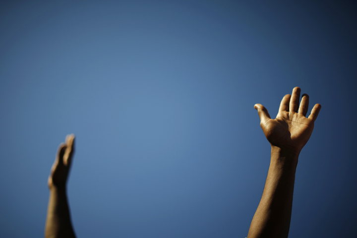 A Los Angeles protester with arms raised participates in a Nov. 25, 2014 march following the grand jury decision in the shooting death of Michael Brown in Ferguson, Mo.(CNS photo/Lucy Nicholson, Reuters)