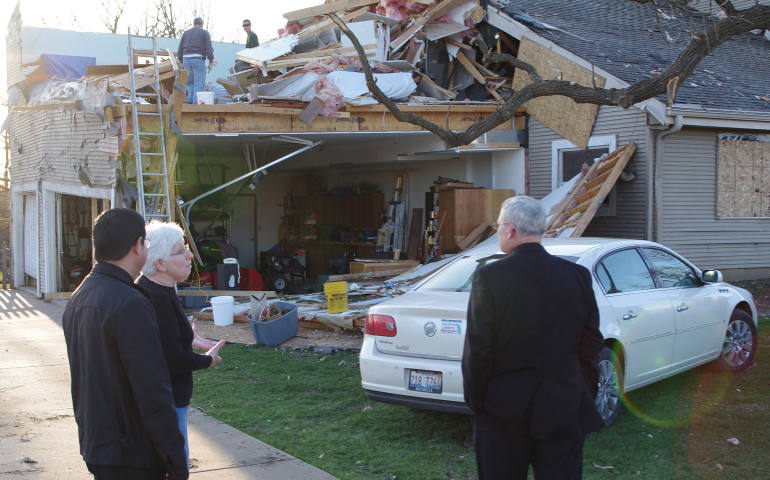 Cecilie Schwartz talks to Fr. Johnson Lopez, pastor of St. Patrick Parish in Rochelle, Ill., and Bishop David J. Malloy of Rockford, Ill., April 11, the EF4 tornado that damaged her home and 29 others in her neighborhood the night of April 9. Bishop Malloy visited the neighborhood after celebrating Mass at St. Patrick Church in Rochelle to pray for tornado victims and their families. (CNS photo/Penny Wiegert, Catholic Observer)