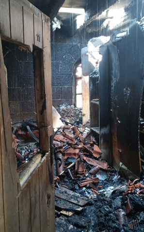 A burned-out section of the Benedictine Church of the Multiplication at Tabgha, Israel, is seen after an arson fire in late June. The Assembly of the Catholic Ordinaries of the Holy Land filed an official complaint to Israeli police against the leader of a radical Israeli movement over his remarks supporting and encouraging the burning of churches. (CNS photo/courtesy Catholic Church in Jerusalem) 