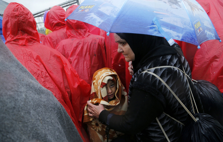 A child looks on as migrants wait at the Slovenia border in Trnovec, Croatia, Oct. 19. A Vatican official has stressed the importance of migrant integration and human dignity. (CNS photo/Antonio Bronic, Reuters)