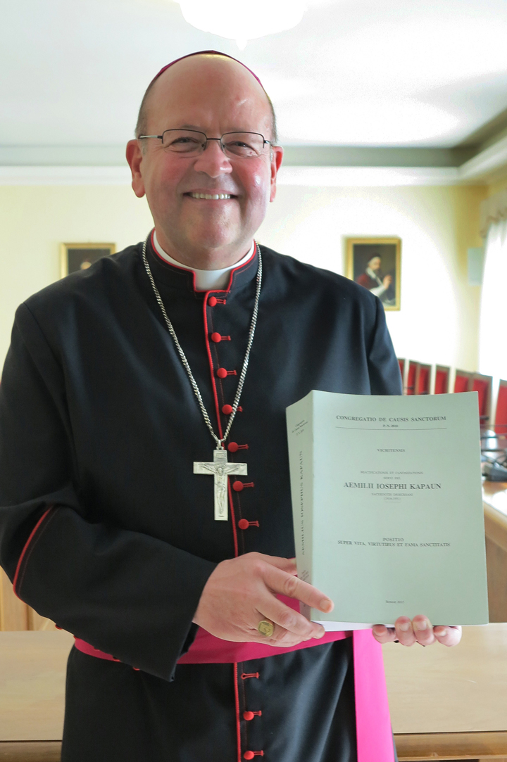 Bishop Carl A. Kemme of Wichita, Kan., holds a 1,066-page report on the life and holiness of Father Emil J. Kapaun that he formally delivered Nov. 9 to the Congregation for Saints’ Causes at the Vatican. Father Kapaun, a priest of the Diocese of Wichita and an Army chaplain, died in a North Korean prison camp in 1951. (CNS/Cindy Wooden)