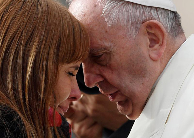 Pope Francis talks with a woman during his general audience in St. Peter's Square at the Vatican Nov. 18, 2015. (CNS/Paul Haring)