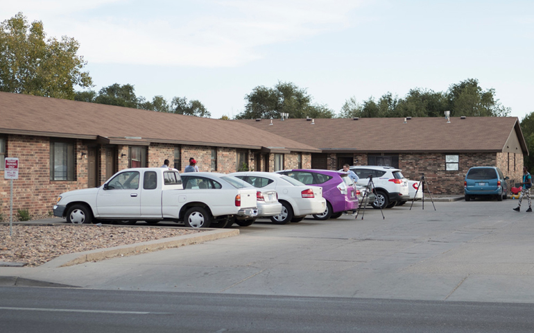 People stand outside a mosque located within an apartment complex, Oct. 14, in Garden City, Kan., which federal authorities allege was to be targeted in a bomb plot. (Reuters/Adam Shrimplin)