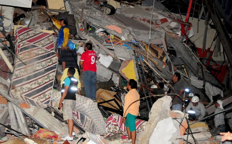 People search for victims in the rubble of a destroyed building in Manta, Ecuador, April 16 after an 7.8-magnitude earthquake struck the region. At least 350 people died, nearly were 3,000 injured and thousands were left homeless. (CNS photo/Paul Ochoa, Reuters)