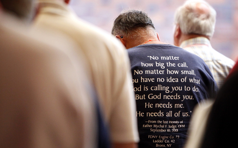 Members of the Association of U.S. Catholic Priests bow their heads in prayer during a Mass celebrated June 30, 2016, during the organization's gathering in Chicago. (CNS/Karen Callaway, Catholic New World)