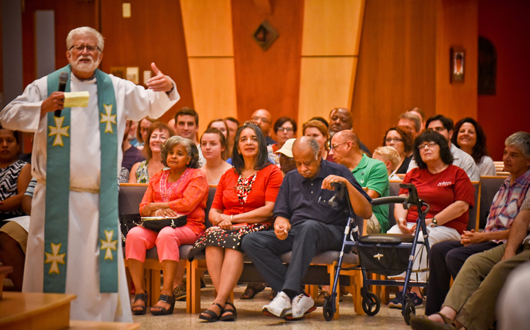 Father Bob Stiefvater, pastor of All Saints Parish in Milwaukee, asks Catholics at an Aug. 18 Mass to build bridges of peace. (CNS photo/Juan C. Medina, Catholic Herald)