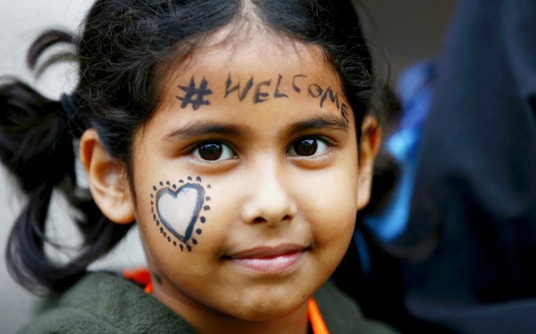 A young demonstrator marches in London Sept. 17, 2016, during a protest in support of refugees. (CNS/Reuters/Peter Nicholls)