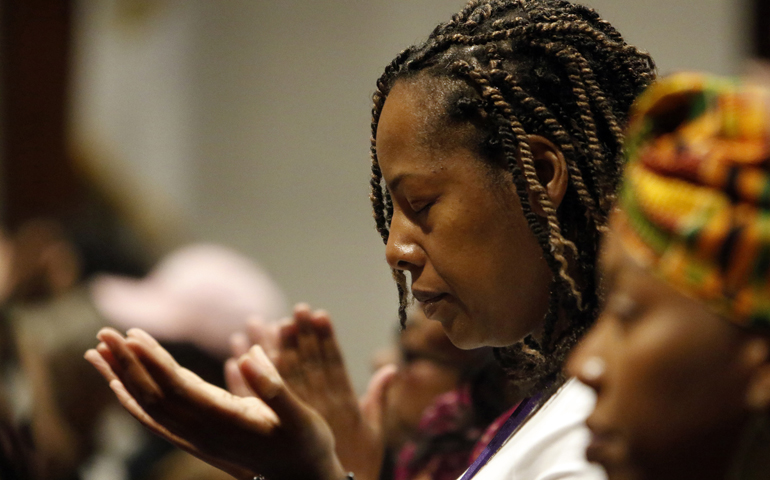 A woman prays during Mass Nov. 12, 2016, at St. Martha Church in Uniondale, New York. (CNS/Gregory A. Shemitz)