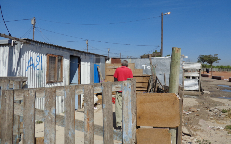 : Gerald Flagg, a community worker for a South African HIV outreach project with international Catholic funding, prepares to check in on a family affected by HIV in the Cape Town township of Blikkiesdorp Nov. 15. (CNS photo/Bronwen Dachs)