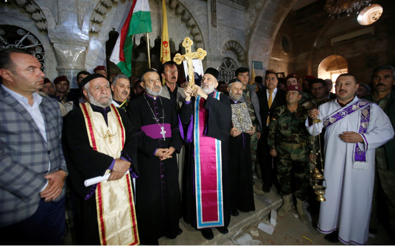 Iraqi Christians take part in a Nov. 19 procession to erect a new cross over a church, after the original cross was destroyed by Islamic State militants in the town of Bartella, Iraq, near Mosul. (CNS / Reuters / Azad Lashkari)