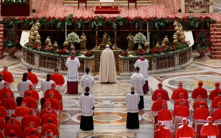 Pope Francis prays as he arrives for a consistory in St. Peter's Basilica at the Vatican June 28. The pope created five new cardinals at the service. (CNS/Paul Haring)