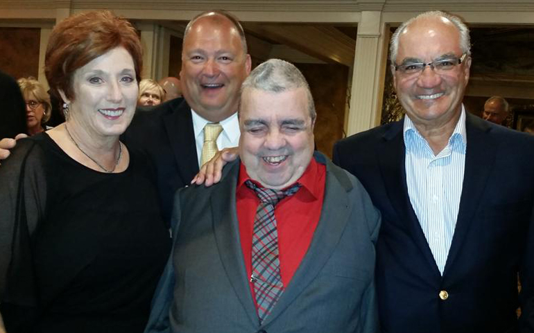 Denise Avagliano, Department for Persons with Disabilities executive director Scott Milliken, Bill, and Denis Avagliano pose at the department's 50th anniversary celebration last September. Bill was honored with a "50 Years of Love Award." (Photo courtesy Department for Persons with Disabilities)