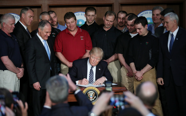 U.S. President Donald Trump signs an executive order titled "Energy Independence" during a March 28 event at the Environmental Protection Agency headquarters in Washington. (CNS photo/Carlos Barria, Reuters)