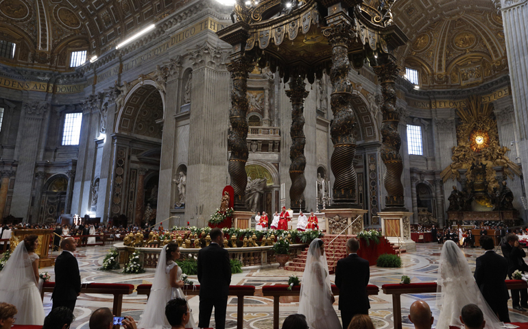 Pope Francis celebrates the marriage rite for 20 couples during a Mass in St. Peter's Basilica at the Vatican Sept. 14, 2014. (CNS/Paul Haring)