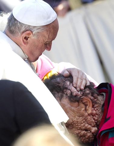 Pope Francis embraces Vinicio Riva, 53, during his general audience in St. Peter's Square at the Vatican Nov. 6. (CNS/EPA/Claudio Peri)