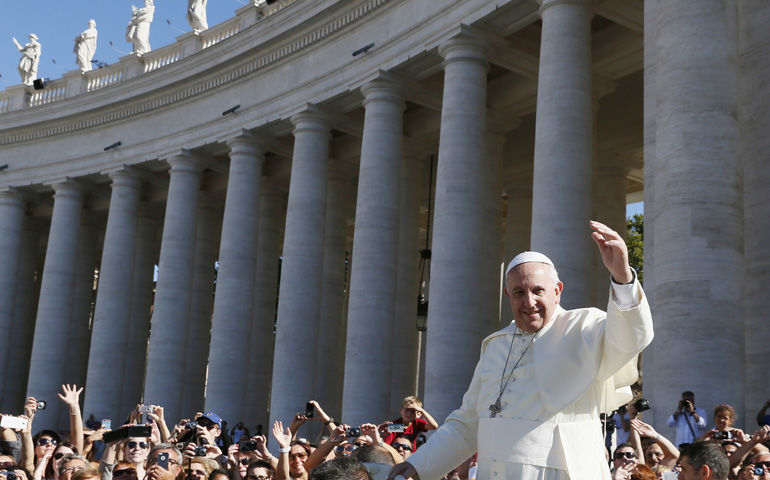 Pope Francis greets the crowd as he arrives to lead his general audience Wednesday in St. Peter's Square at the Vatican. (CNS/Paul Haring)