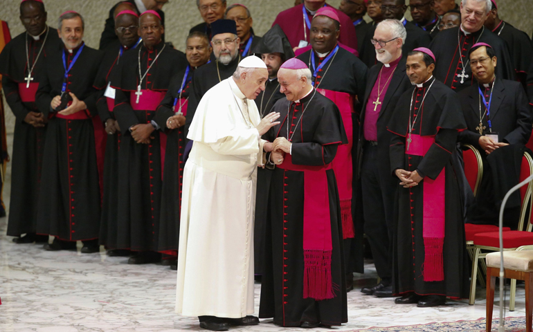 Pope Francis talks with Archbishop Vincenzo Paglia, president of the Pontifical Council for the Family, as the pope arrives to lead his weekly audience Wednesday in Paul VI hall at the Vatican. (CNS/Reuters/Tony Gentile)