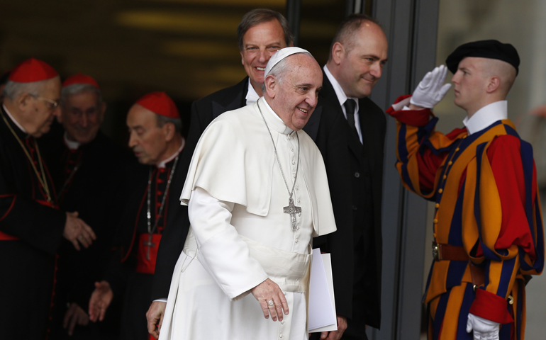 A Swiss Guard salutes as Pope Francis and cardinals leave a meeting in the synod hall at the Vatican Feb. 20. (CNS/Paul Haring) 