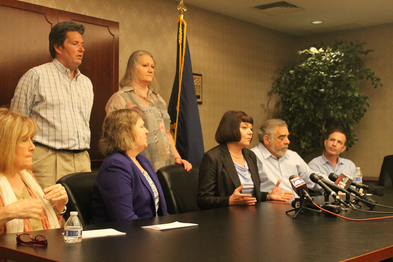 Survivors of sex abuse and their attorneys Rebecca Randles (center) and Sarah Brown (left of Randles) shared their reactions to Bishop Robert Finn’s resignation as head of the diocese of St. Joseph-Kansas City, Mo., during a press conference held April 21 in mid-town Kansas City. (NCR/Brian Roewe)