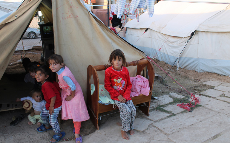 Iraqi children play outside a tent where some 300 Kaka'i are living in Ainkawa, near Irbil in the Kurdistan region of Iraq in late October. (CNS/Dale Gavlak)