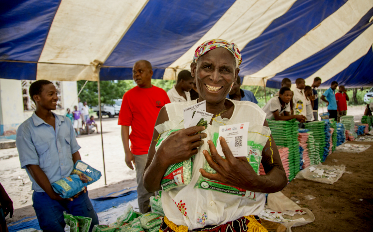 Farmer Alefa Tom peruses seed varieties at a Diversification for Nutrition and Enhanced Resilience (DiNER) seed fair in Chikwawa District, Malawi, on March 17. Catholic Relief Services' DiNER program offers subsidized vouchers to purchase drought-resistant seeds. (CRS/Georgina Goodwin)