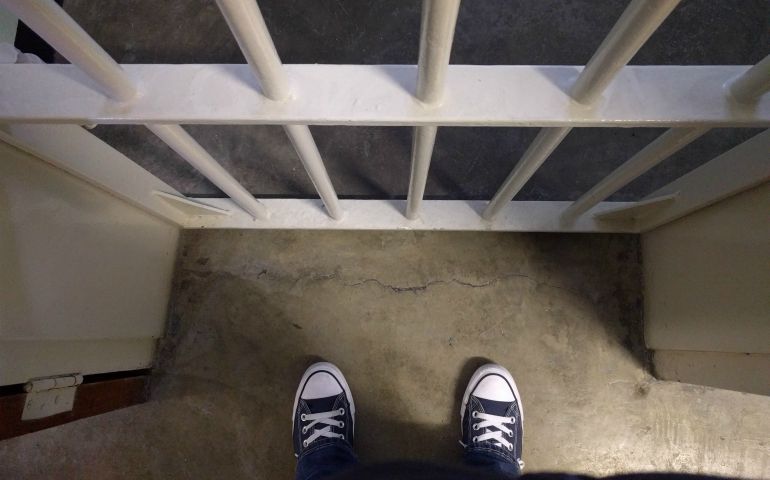 Joceyln Sideco's feet at the door of Nelson Mandela's former cell on Robben Island (Jocelyn Sideco)