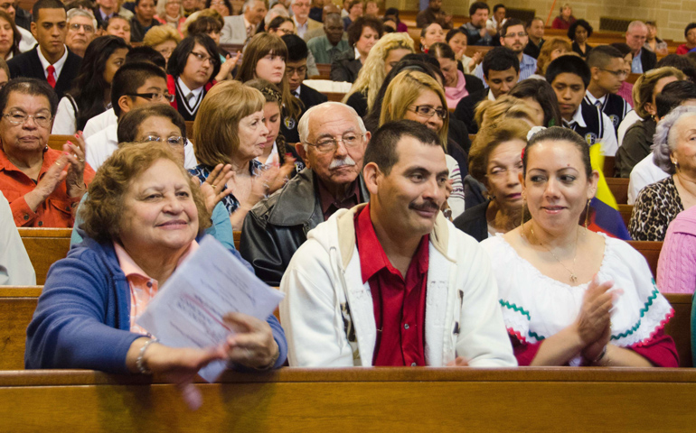 People from the diocese of Trenton, N.J., applaud during the Justice for Immigrants Mass on Oct. 11 at St. Mary of the Assumption Cathedral in Trenton. (CNS/The Monitor/Joe Moore)