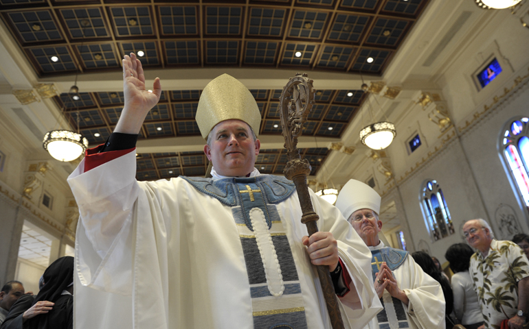 Auxiliary Bishop Peter Smith blesses people in the balcony during his ordination Mass on Tuesday at St. Mary Cathedral of the Immaculate Conception in Portland, Ore. (CNS/Catholic Sentinel/Bob Kerns)