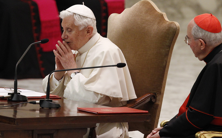 Pope Benedict XVI speaks during an audience with priests of the Diocese of Rome in Paul VI hall at the Vatican Feb. 14. At right is Cardinal Agostino Vallini, papal vicar of Rome. (CNS/Paul Haring)