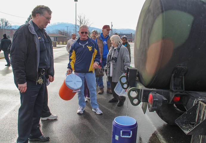 Residents line up for water at a water filling station Friday at West Virginia State University. (CNS/Reuters/Lisa Hechesky)