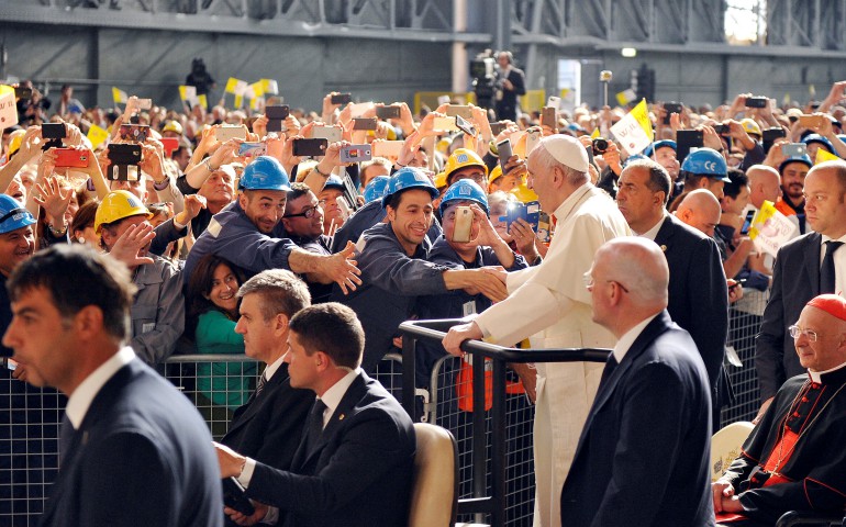 Pope Francis greets workers as he arrives at the ILVA steel plant during his May 27 pastoral visit in Genoa, Italy. (CNS photo/Giorgio Perottino, Reuters)