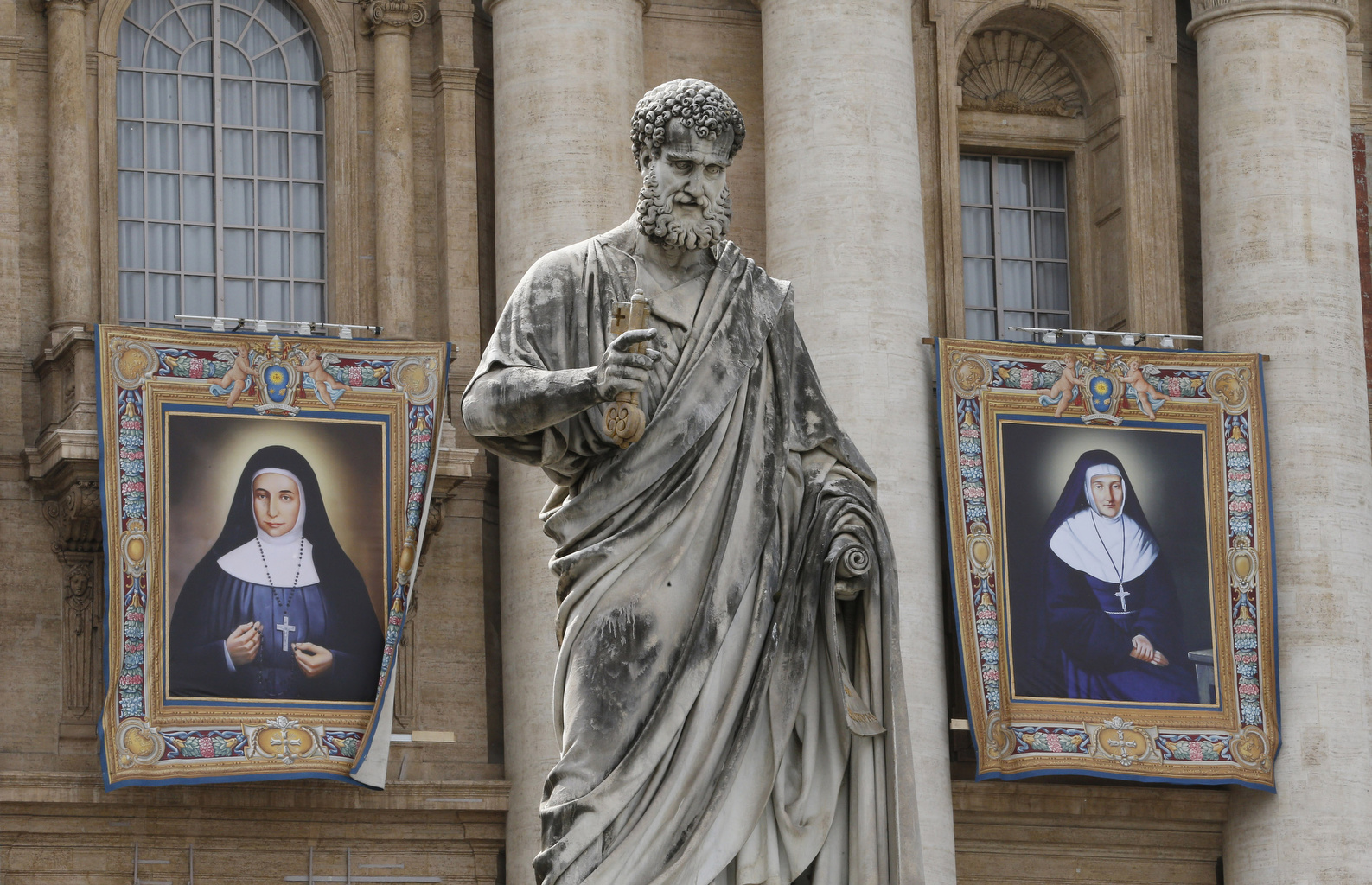 Banners showing Blesseds Marie-Alphonsine and Jeanne Emilie De Villeneuve hang from the facade of St. Peter's Basilica at the Vatican Friday. (CNS/Paul Haring)