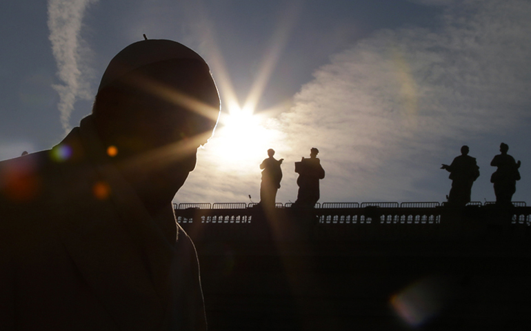 Pope Francis is silhouetted as he arrives to lead the weekly audience in St. Peter’s Square at the Vatican on Dec. 30, 2015. (Reuters/Max Rossi)