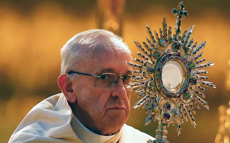 Pope Francis elevates the host as he leads the Corpus Domini procession at the Basilica of Santa Maria Maggiore in Rome on June 18, 2017. (Courtesy of Reuters/Tony Gentile)