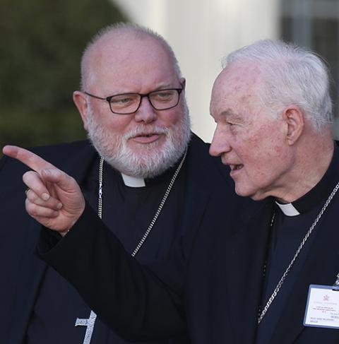 Cardinal Reinhard Marx of Munich and Freising, Germany, and Cardinal Marc Ouellet talk as they leave a session of the Synod of Bishops for the Amazon at the Vatican Oct. 21, 2019. (CNS/Paul Haring)