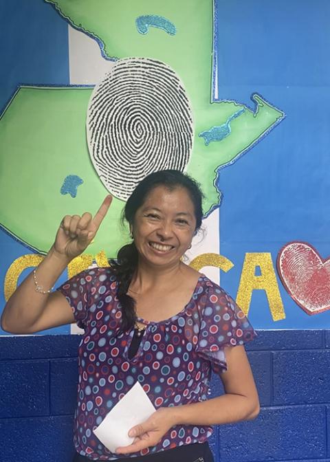 Linda Cecilia Orozco Citalán shows off her inked finger, proof that she voted in Guatemala's run-off election Aug. 20. The election felt like a "civic fiesta," said Orozco, a Catholic psychologist, who said there's an eroding middle class in the country, something that voters like her want to see change with their choice for president. (NCR photo/Rhina Guidos)