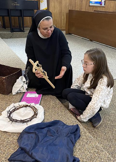 Mother Maria Irina Teiner, a Franciscan Sister of Christ the Light, prepares Isabella Johnson for first Communion in an undated photo. (Courtesy of Franciscan Sisters of Christ the Light)