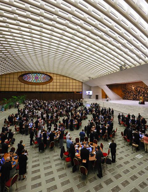 Members of the assembly of the Synod of Bishops pray with Pope Francis before a working session in the Vatican's Paul VI Audience Hall Oct. 16. (CNS/Lola Gomez)