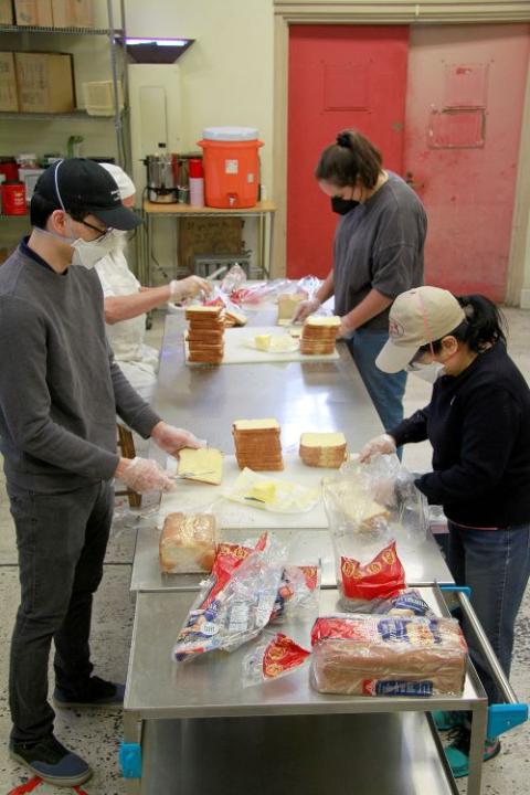 Volunteers work in the Los Angeles Catholic Worker soup kitchen. LA Catholic Worker Jeff Dietrich, who has lived and worked among the poor of Skid Row since 1970, said the work "keeps me in contact with reality when I become too complacent, too comfortable in my own bed." (Mike Wisniewski)