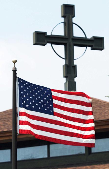 A file photo shows an American flag flying outside a Catholic church in New York. (OSV News/Long Island Catholic/Gregory A. Shemitz)