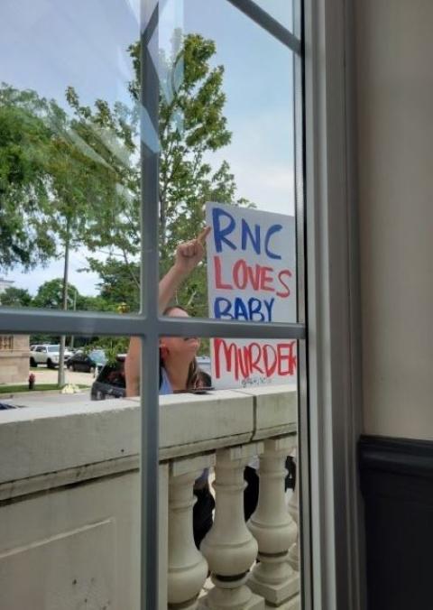 An anti-abortion protester holds up a sign outside a July 16 event sponsored by Georgetown University as part of the Republican National Convention in Milwaukee. 