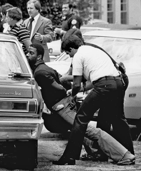 Police handcuff a suspect during a drug raid in Miami, May 18, 1979. (AP/Al Diaz, File)