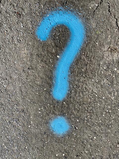 A light-blue question mark has been spray painted on a concrete surface in this photo illustration. (Unsplash/Massimo Virgilio)